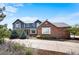 Beautiful two-story home with a blue and brick exterior, landscaped front yard, and long driveway at 19052 E Briarwood Dr, Centennial, CO 80016