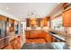 Spacious kitchen with stainless steel appliances, granite countertops, and wooden cabinets at 19052 E Briarwood Dr, Centennial, CO 80016