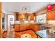 Modern kitchen featuring wooden cabinetry, granite countertops, and stainless steel appliances at 19052 E Briarwood Dr, Centennial, CO 80016
