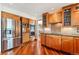 Modern kitchen boasts stainless steel appliances, wood cabinetry, and hardwood floors at 19052 E Briarwood Dr, Centennial, CO 80016