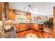 Bright kitchen features wood cabinets, granite counters, stainless steel appliances, and hardwood floors at 19052 E Briarwood Dr, Centennial, CO 80016