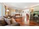 Cozy living room with hardwood floors, comfortable seating, and a beautiful piano at 19052 E Briarwood Dr, Centennial, CO 80016