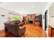 Cozy living room with hardwood floors, a fireplace, custom built-ins, and natural light at 19052 E Briarwood Dr, Centennial, CO 80016
