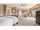 Bedroom featuring decorative walls, a seating area by a window, and an arched doorway to the main bathroom at 19052 E Briarwood Dr, Centennial, CO 80016