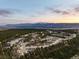 Breathtaking aerial view of a residential area nestled among trees with a mountain view in the background at 1775 Catnap Ln, Monument, CO 80132