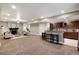 Wide angle view of finished basement with living room, bar area, and stairs at 1775 Catnap Ln, Monument, CO 80132
