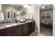 Elegant bathroom featuring double sinks, granite countertops, and modern fixtures with bedroom access at 1775 Catnap Ln, Monument, CO 80132
