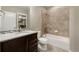 Bathroom features granite countertop, tile backsplash, and tub-shower combo at 1775 Catnap Ln, Monument, CO 80132