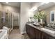 Spacious bathroom featuring double sinks, granite countertops, soaking tub, and glass enclosed shower at 1775 Catnap Ln, Monument, CO 80132