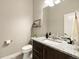 Stylish bathroom featuring a granite countertop, ample vanity storage, and modern fixtures at 1775 Catnap Ln, Monument, CO 80132