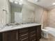 This bathroom features a modern vanity, granite countertop, and tiled shower and bathtub combination at 1775 Catnap Ln, Monument, CO 80132