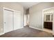 Neutral bedroom featuring grey carpet, base molding and ensuite bathroom view at 1775 Catnap Ln, Monument, CO 80132