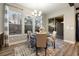 Cozy dining area with a stylish rug, a round table, and a sliding glass door to outdoor scenery at 1775 Catnap Ln, Monument, CO 80132