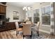 Bright dining area featuring a modern chandelier, wood floors, and abundant natural light from multiple windows at 1775 Catnap Ln, Monument, CO 80132