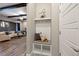 Entryway with a built-in bench and coat rack, leading into the open-concept living space at 1775 Catnap Ln, Monument, CO 80132