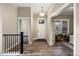 Warm foyer with hardwood floors, a welcoming entry door, and a view into a bright living area at 1775 Catnap Ln, Monument, CO 80132