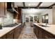 Modern kitchen featuring stainless steel appliances, dark cabinetry, and a view into the dining area at 1775 Catnap Ln, Monument, CO 80132