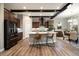 Kitchen with an island, barstool seating, dark wood cabinets, and stainless steel appliances at 1775 Catnap Ln, Monument, CO 80132