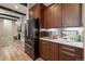 Close up of kitchen features, wood cabinetry, stainless steel appliances, and view of fireplace at 1775 Catnap Ln, Monument, CO 80132