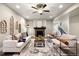 Cozy living room with fireplace, ceiling fan, sofa and neutral chairs on a stylish rug at 1775 Catnap Ln, Monument, CO 80132