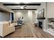 Spacious living room featuring hardwood floors, a fireplace, and neutral-toned walls at 1775 Catnap Ln, Monument, CO 80132