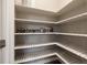 Walk-in pantry with patterned shelves and ample storage space for all your kitchen needs at 1775 Catnap Ln, Monument, CO 80132