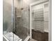 Modern glass enclosed shower with tile surround and bench seating leading to walk-in closet at 1775 Catnap Ln, Monument, CO 80132