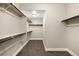 Walk-in closet with carpet and white built-in shelving for ample storage at 1775 Catnap Ln, Monument, CO 80132