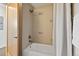 Bathroom with a tub and tiled walls with glass door and nice fixtures at 1585 Hecla Way # 201, Louisville, CO 80027
