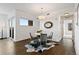 Cozy dining area with a round table, stylish chairs, and a unique cowhide rug under a modern light fixture at 1585 Hecla Way # 201, Louisville, CO 80027