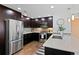 Modern kitchen with stainless steel appliances, dark cabinets, and a quartz countertop island with seating at 1585 Hecla Way # 201, Louisville, CO 80027