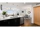 Bright, open-concept kitchen featuring an island with seating that looks onto the dining and living areas at 1585 Hecla Way # 201, Louisville, CO 80027