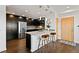 Sleek kitchen with stainless steel appliances, dark cabinets, and a quartz countertop island with seating at 1585 Hecla Way # 201, Louisville, CO 80027