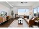 A sunlit living room with a modern brown leather sofa, accent chair, and a stylish area rug at 1585 Hecla Way # 201, Louisville, CO 80027