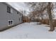 Large backyard featuring wooden fence, deck with stairs, and gray home exterior at 12425 Albion St, Thornton, CO 80241