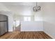 Bright living room featuring hardwood floors, a modern chandelier, and neutral color scheme at 12425 Albion St, Thornton, CO 80241