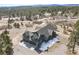 An aerial view capturing the home's modern design and extensive, multi-car garage at 5800 Elk View Ct, Larkspur, CO 80118