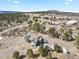 Aerial view of the home showcasing its location, long driveway, and treed landscape at 5800 Elk View Ct, Larkspur, CO 80118