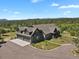Stunning aerial view of the green home, with a spacious driveway and scenic mountain views at 5800 Elk View Ct, Larkspur, CO 80118