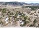 The aerial view highlights the home's location in a sprawling, natural environment at 5800 Elk View Ct, Larkspur, CO 80118