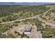 Overhead view showcases a home with an attached three-car garage and a secluded surrounding at 5800 Elk View Ct, Larkspur, CO 80118
