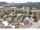 An aerial view showing the property's layout, treed acreage, and proximity to roads at 5800 Elk View Ct, Larkspur, CO 80118