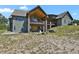 Expansive backyard featuring a covered patio with a fire pit and ample seating, ideal for outdoor entertaining at 5800 Elk View Ct, Larkspur, CO 80118