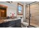 Modern bathroom features granite counters and a sleek glass-enclosed shower at 5800 Elk View Ct, Larkspur, CO 80118