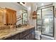 Well-appointed bathroom with stone counters, modern vanity, and frameless glass shower at 5800 Elk View Ct, Larkspur, CO 80118