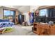 Bright bedroom with views, a comfortable bed, and a well-organized desk area at 5800 Elk View Ct, Larkspur, CO 80118