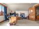 Bright bedroom features a window with natural light, a workspace, and carpeted floors at 5800 Elk View Ct, Larkspur, CO 80118