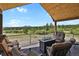 Enjoy breathtaking mountain views from this beautiful deck with a cozy seating area and fire pit at 5800 Elk View Ct, Larkspur, CO 80118