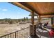 Spacious covered deck boasts picturesque views of the surrounding natural landscape at 5800 Elk View Ct, Larkspur, CO 80118