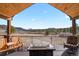 Covered deck with mountain view, fire pit, and ample seating is great for entertaining at 5800 Elk View Ct, Larkspur, CO 80118